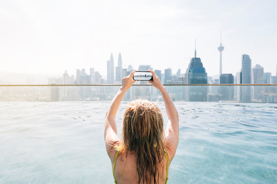 Woman taking photos in the pool