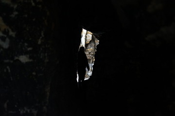 Silhouette of a man exploring the inside of a sandstone cave