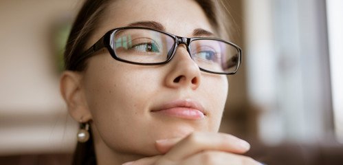 Myopia or hyperopia, woman looking through optical eyeglasses