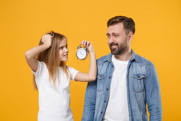 Confused bearded man in casual clothes with child baby girl. Father little kid daughter isolated on...