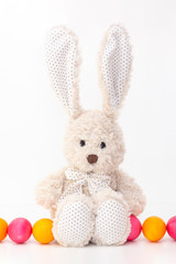 Easter eggs cute bunny with long ears. Happy easter. painted eggs on a light background. vertical photo