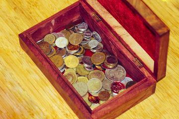 Vintage wooden vintage retro jewelry box with metal coins from different countries