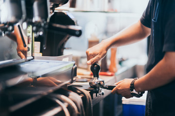 Barista uses the coffee powder compacting tool. To produce coffee with a specific flavor of the coffee shop The aroma of fragrant coffee roasted throughout the store. Giving a fresh feeling