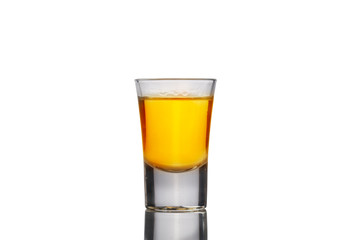 Shot glass of strong alcohol whisky isolated on white bakcground