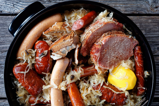 Sour cabbage stew with meat and sausage, close-up