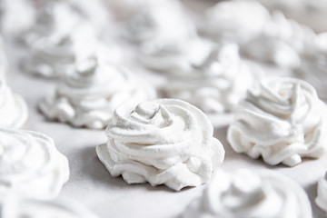 on a white pastel background lies a fresh white handmade marshmallow