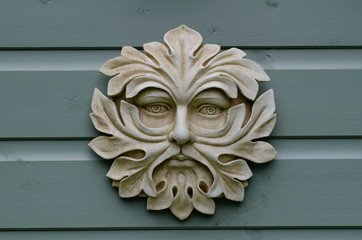 Stylized pottery face of the 'Green Man' as a wall plaque