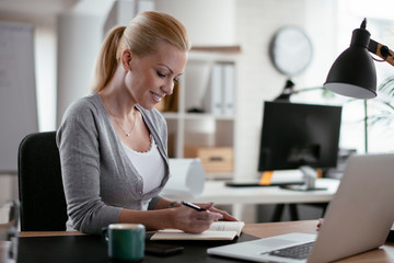 Young woman at work. Beautiful businesswoman working in office.	