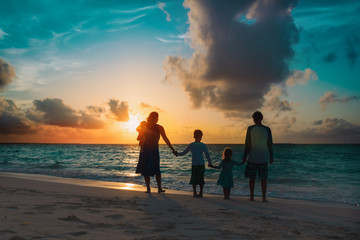 happy family with kids walk at sunset beach - 329335841