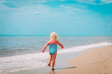 Fototapeta na wymiar little girl going to swim at beach vacation