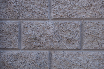 Gray brick wall. Torn concrete structure. Creative vintage background.