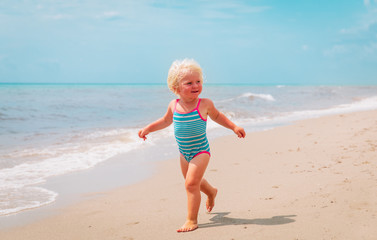 cute little girl going to swim at beach vacation