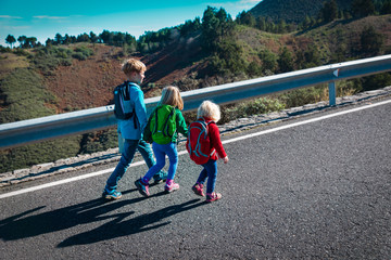 kids travel by road in mountains, family vacation in nature