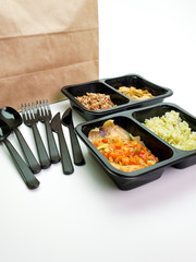 Delicious and healthy takeaway food in boxes with Cutlery.