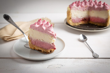 Delicious homemade cheesecake with berries on wooden table.