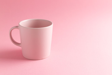 Empty pink Mug on pink background with copy space