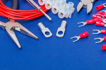 Big kit spare parts and tool, red wires for electrical prepared before repair or setting on blue workshop table