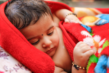 Cute indian little boy playing on bed 