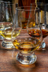 Tasting of flight of Scotch whisky from special tulip-shaped glasses on distillery in Scotland, UK