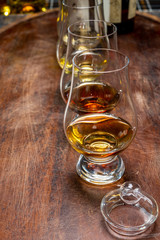 Tasting of flight of Scotch whisky from special tulip-shaped glasses on distillery in Scotland, UK