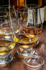 Tasting of flight of Scotch whisky from special tulip-shaped glasses on distillery in Scotland, UK