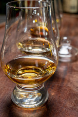 Tasting of flight of Scotch whisky from special tulip-shaped glasses on distillery in Scotland, UK