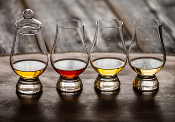 Tasting of flight of Scotch whisky from special tulip-shaped glasses on distillery in Scotland, UK