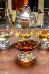 Tasting of flight of Scotch whisky from special tulip-shaped glasses on distillery in Scotland, UK