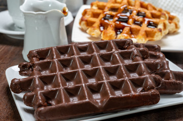 Tasty Belgian dessert, Brussels waffles with chocolade, syrup and white sugar powder