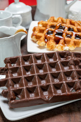 Tasty Belgian dessert, Brussels waffles with chocolade, syrup and white sugar powder