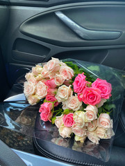A bouquet of roses flowers for lady in the front seat of the car