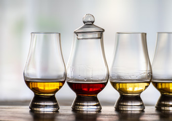 Tasting of flight of Scotch whisky from special tulip-shaped glasses on distillery in Scotland, UK