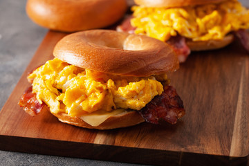breakfast egg and bacon sandwich on bagel with cheese