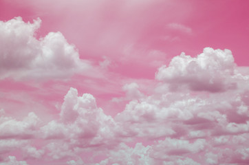Pink sky with white clouds and blurred pattern background