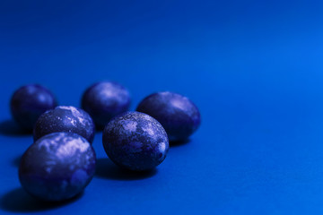 Eggs with marble stone blue effect painted with natural dye carcade flower on blue sparkling background