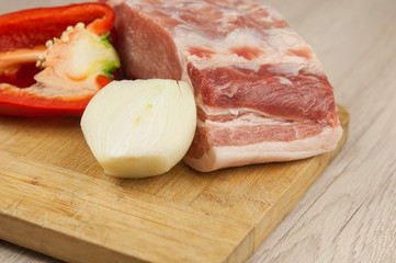 Raw pork meat on wood cutting board