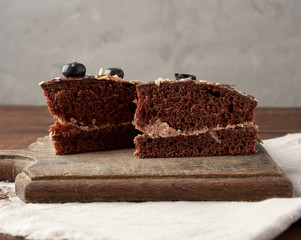 triangular piece of chocolate biscuit cake with butter cream