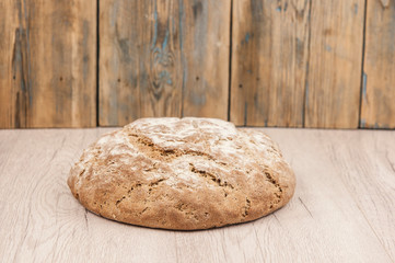 Round loaf of freshly backed sourdough bread, with copy space