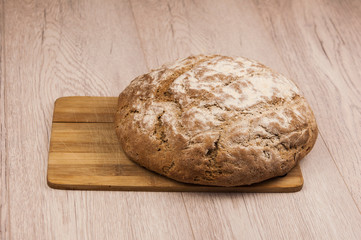 Round loaf of freshly backed sourdough bread, with copy space