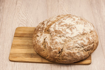Round loaf of freshly backed sourdough bread, with copy space