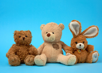 cute curly brown teddy bears and bunny, concept of support and friendship