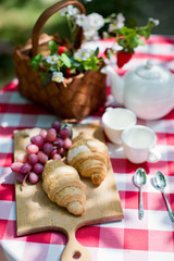 Tasty croissants with grape on the wooden desk