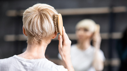 Unrecognizable Woman Brushing Hair Standing In Bathroom, Panorama, Back View
