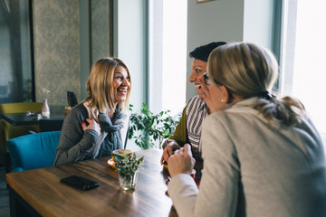 women friends on coffee break in cafe