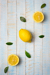Ripe lemons on light blue wooden background