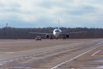 Rear view of a passenger plane while taxiing to runway.