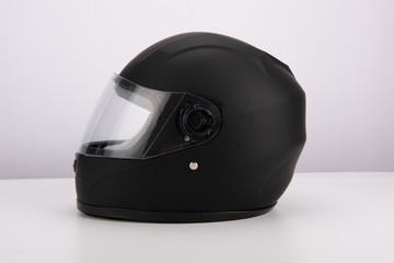 Black motorcycle helmet with wind shield and sun visor, classic helmet isolated on white background