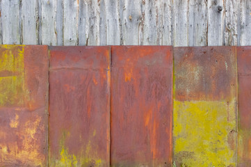 Background old boards are partially sheathed with rusty metal.