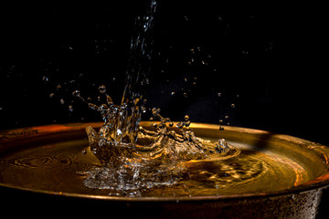 A stream of water flows into the copper wash basin