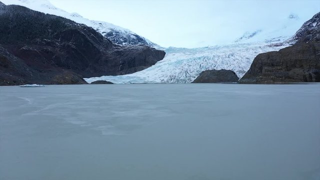 Aerial shot of some icebergs below an amazing glacier in Alaska. Filmed in 4K 30fps